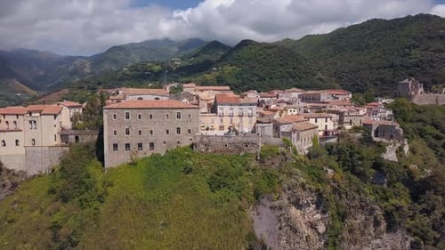 Aerial View of Medieval City on Hill Overlooking the Sea Coast Village and Mountains, Sunny Day