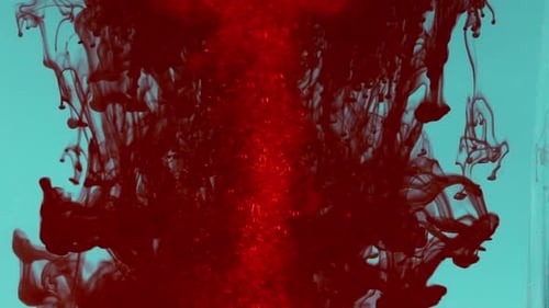 Red Ink Liquid Dispersing in Light Blue Water
