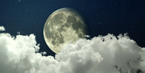 Moving Clouds Pass Over Full Moon at Night