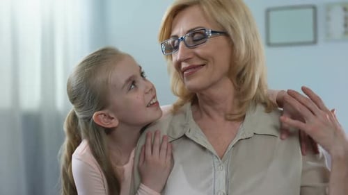 Granddaughter Embraces Blond Grandmother Affectionately Indoors