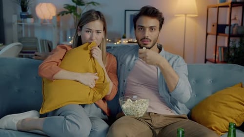 Couple Watching a Scary Movie at Home