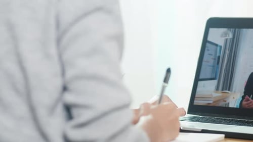 Young Asia teen girl university student using laptop computer distance learning lesson.