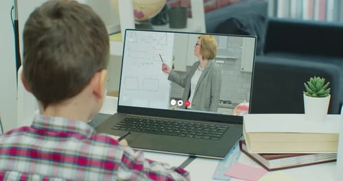Boy Attends Online Math Class at Home