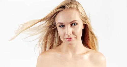 Beautiful Blonde Woman Smiling with Hair Flowing