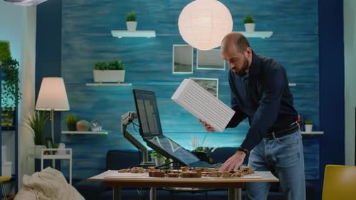 Architect Examining Building Model With Computer Monitor