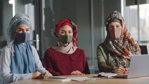 Portrait of Muslim Female Colleagues in Hijabs and Masks