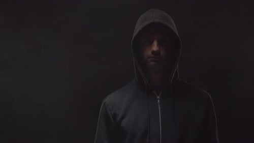 Man with Hooded Sweatshirt in Dim Lighting