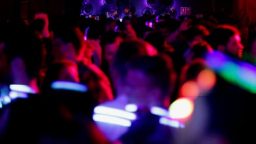 Crowd Dancing at a Nightclub With Colorful Lights