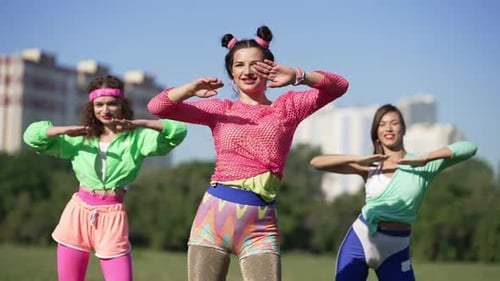 Women Exercising Outdoors in Retro Fashion