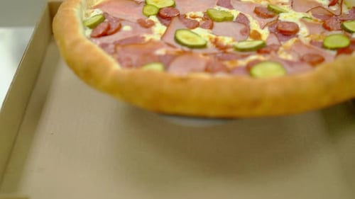 Delicious Pizza in Cardboard Delivery Box Close-Up