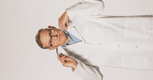 Male Doctor Putting Stethoscope Around Neck