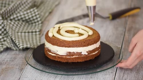 Pastry Chef's Hands Making Carrot Cake with Cream