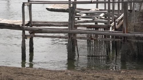 Dilapidated Pier Over Calm Grey Water
