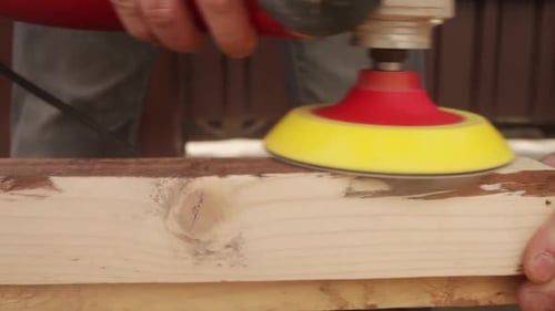 Power Sander Smoothing Wooden Plank Surface