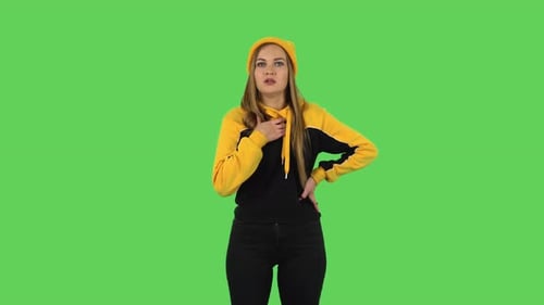 Young Woman Fanning Herself on Green Screen