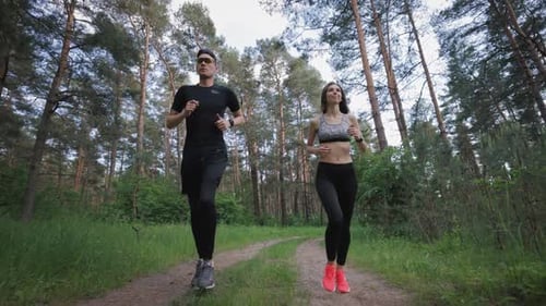 Active Couple Running at Forest