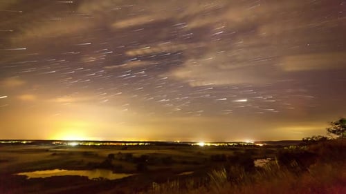Star Trail Time Lapse over Rural Landscape