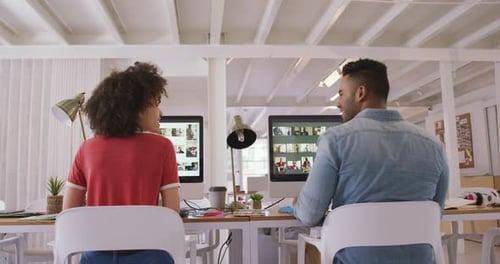 Two colleagues working in creative office