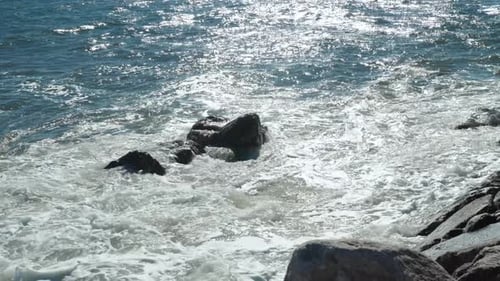 Wave of the Sea on the Sand Beach Rocks