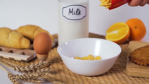 Pouring Cereal into Bowl for Breakfast