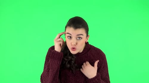 Indignant Woman Throwing Up Hands Expressing She Is Innocent, Twists His Finger at His Temple. Green