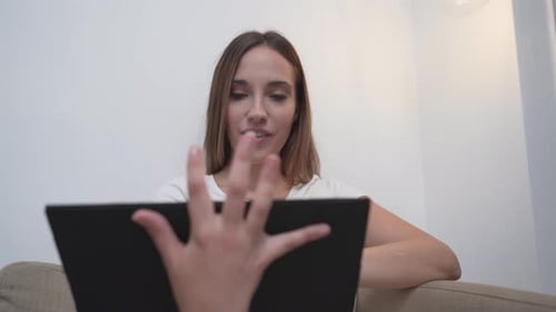 Woman Interacting with Tablet Touch Screen at Home