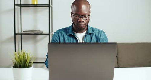 Man Working on Laptop in Home Office