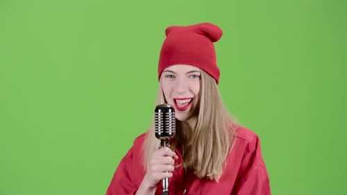Singer Performs Lyrical Songs in a Retro Microphone. Green Screen