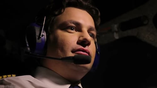 Man Pilots Plane in Dark Cockpit