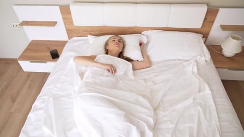 Blonde Woman Waking Up in Bed