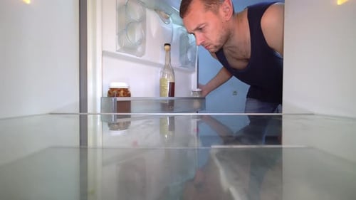 Man Opens Empty Fridge, Looks Disappointed