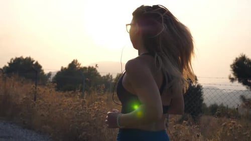Follow to Sporty Girl Jogging in Country Road
