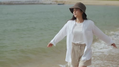 Caucasian female happiness walking on the beach on a holiday weekend.