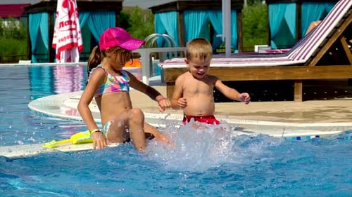 Children in the Pool Splashing Water