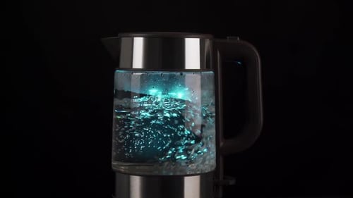 Water Boiling in Glass Electric Kettle with Blue Light