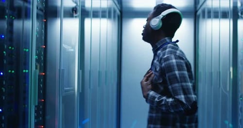 Man Dancing in Server Room Wearing Headphones
