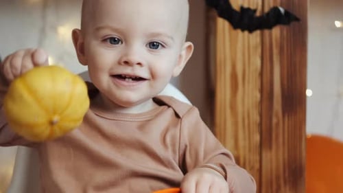 Smiling Infant with Halloween Decorations