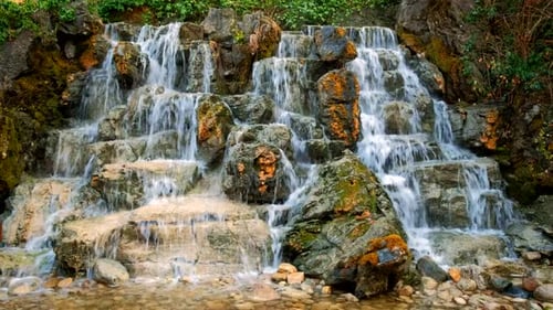 Beautiful Waterfall Flowing Over Mossy Rocks