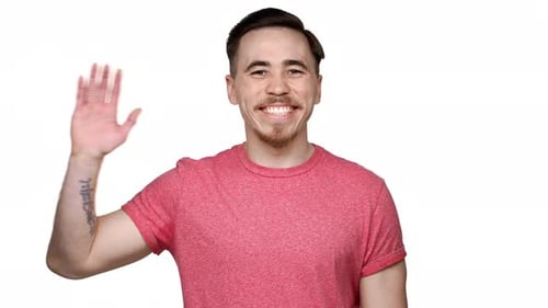 Smiling Man Waving Hand in Friendly Greeting