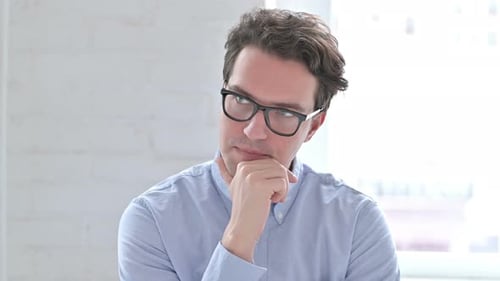 Young Adult Man Thinking with Hand on Chin