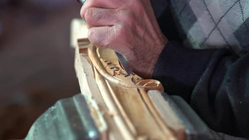 Man Carving Wood Close Up in Workshop
