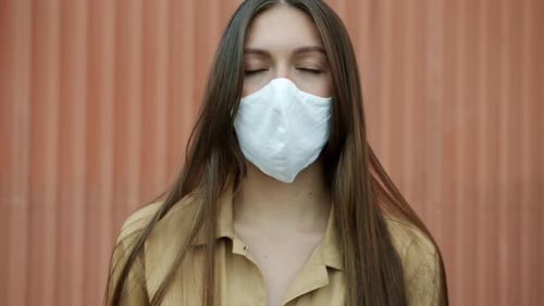 Woman with Mask Standing Still Outside