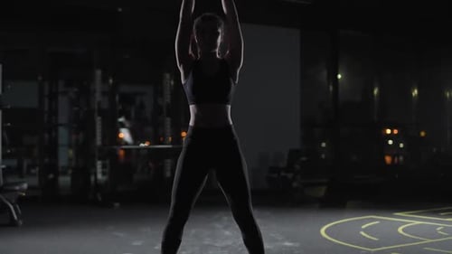 Caucasian Athletic Female Performs Exercises with Kettlebells Lifts Weights and Does Kettlebell