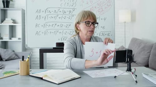Woman Teaches Math Lesson at Home via Video