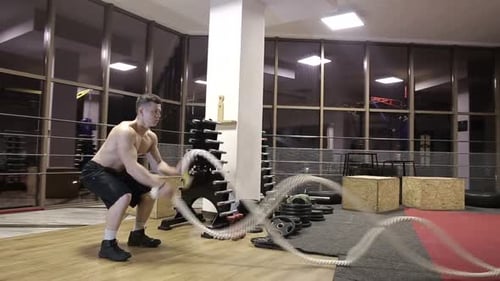 Session battle ropes. an athlete who develops a gym in a functional training