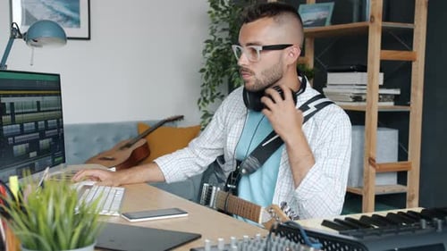 Man Recording Music at Home Studio