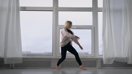Blonde Woman Dances Barefoot in Studio