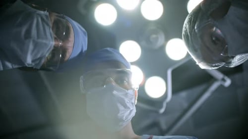 POV Shot of Surgeons Performing Tests on Patient
