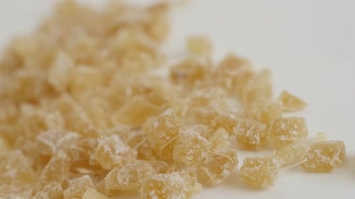 Shallow DOF crystallized Zingiber officinale cubes on pile 4K 2160p 30fps UltraHD panning footage