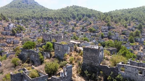 Drone flight close-up over the ruins of an ancient fortress located in the green mountain hills of T